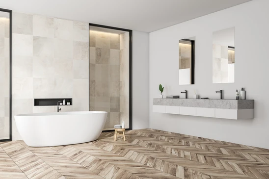 Salle de bain moderne avec baignoire îlot blanche, douche à l'italienne carrelée beige, double vasque suspendue en béton ciré, miroirs rectangulaires noirs